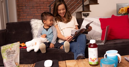 Woman and child reading magazine