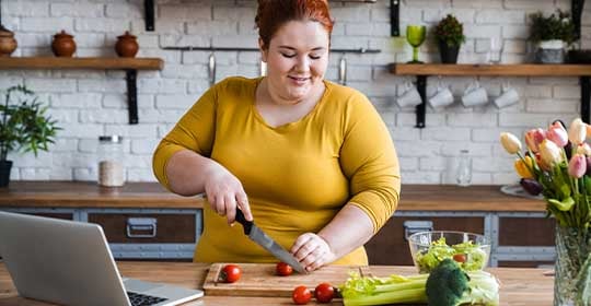 Woman cutting vegetables in a kitchen