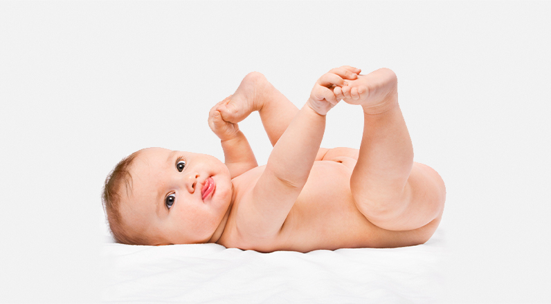 A baby laying on a changing table