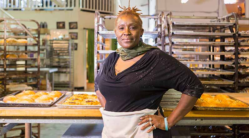 A woman standing in her bakery