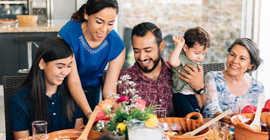 A hispanic family enjoying a meal together