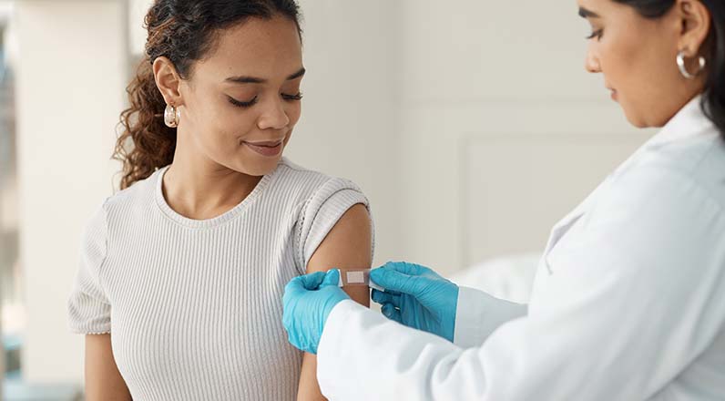 woman getting bandaid put on