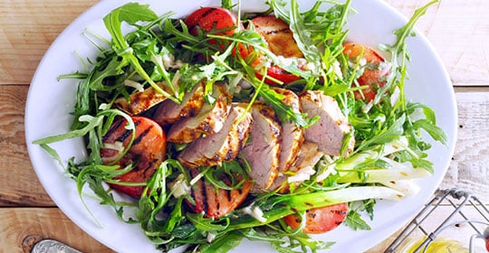 grilled chicken on a bed of greens