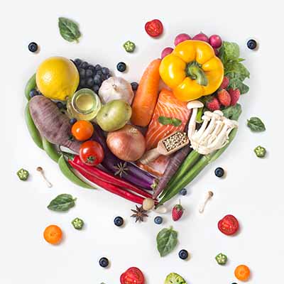 Produce laid out in the shape of a heart on a counter