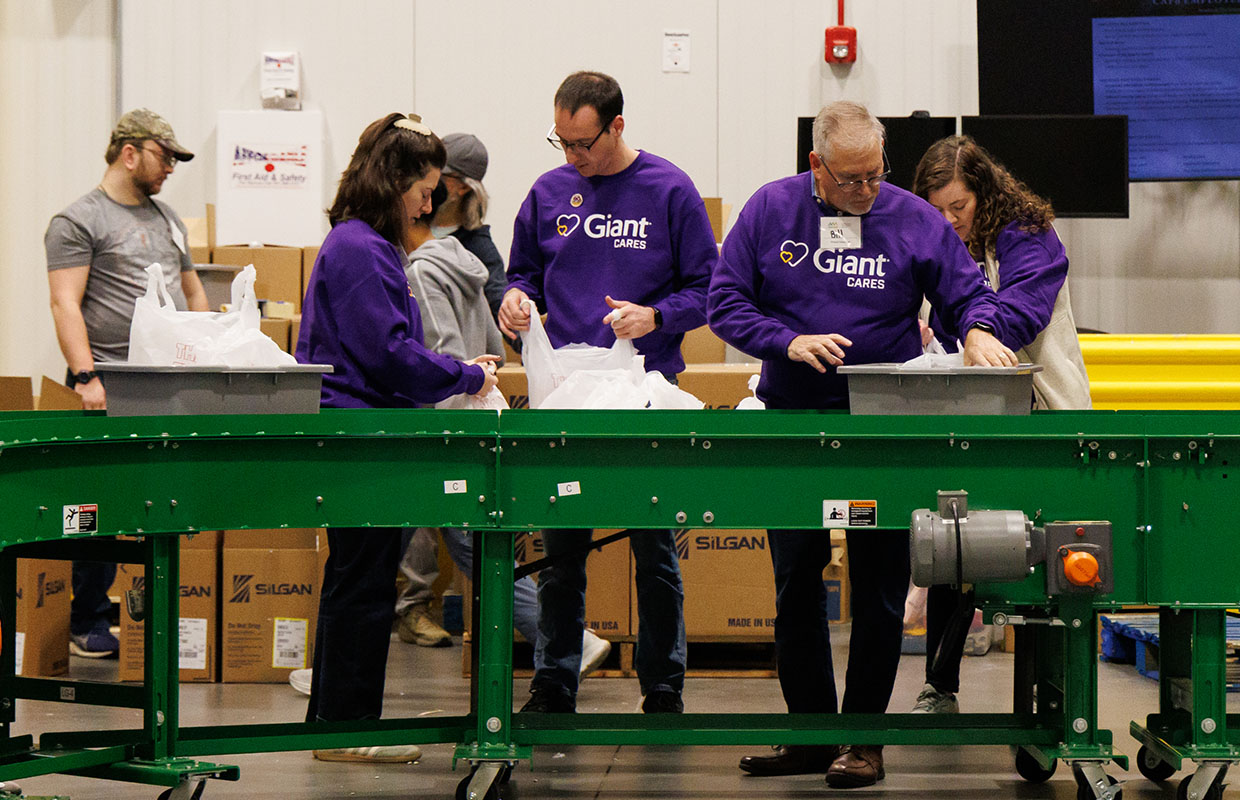 Giant employees packing groceries