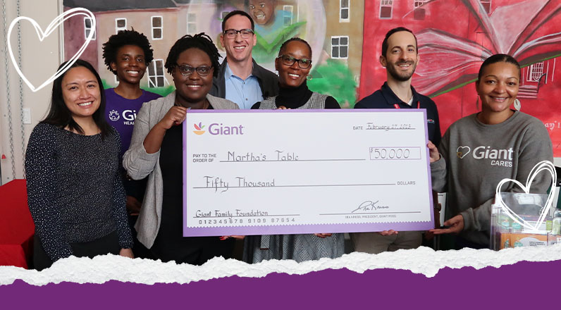 Giant associates presenting a check to charity