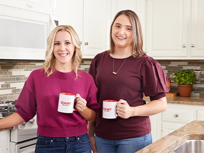 two employees on the wellbeing team smiling